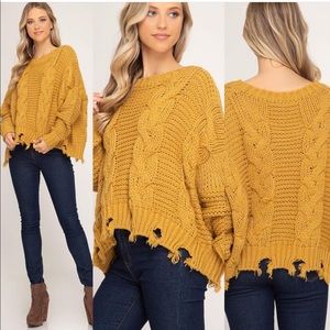 Mustard cable knit frayed hem sweater.